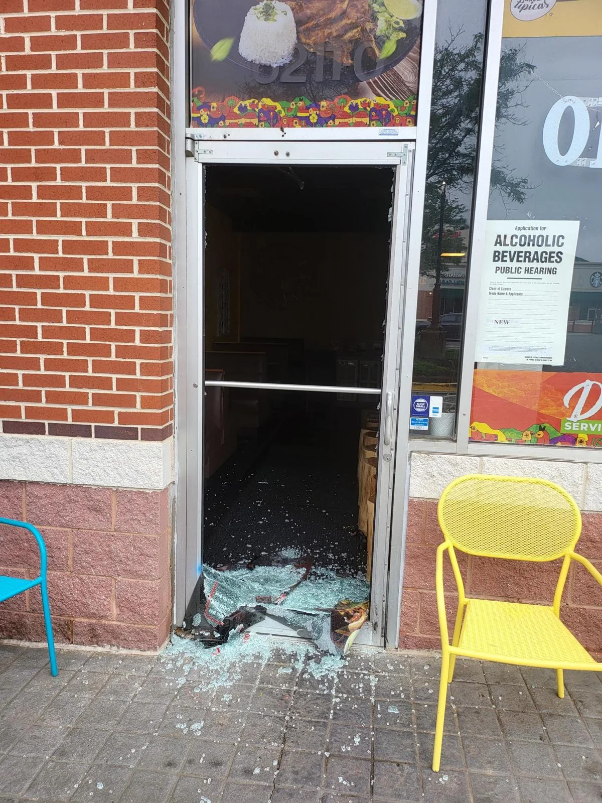 Broken storefront glass before repair